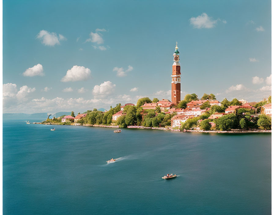 Tranquil Lakeside Town with Bell Tower, Greenery, and Boats