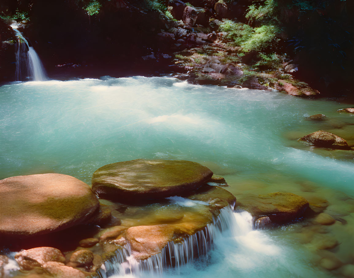 Tranquil waterfall cascading into azure pool amid lush greenery