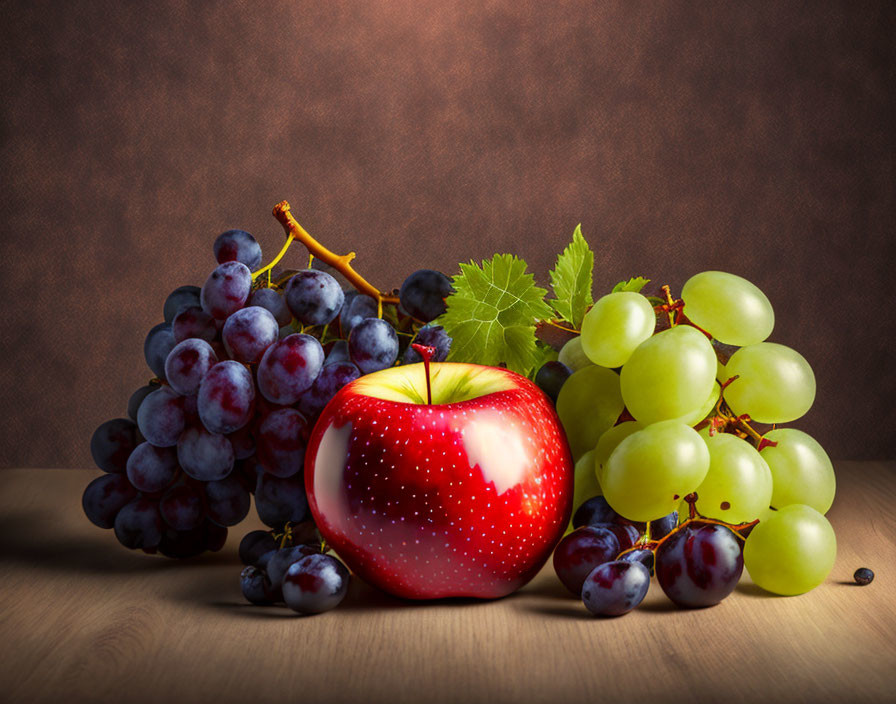 Fresh red apple and grapes with droplets on wooden surface