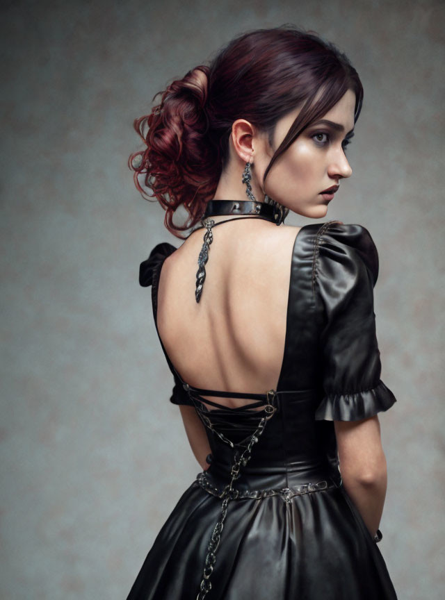 Auburn-Haired Woman in Black Satin Dress with Choker and Chain Detail