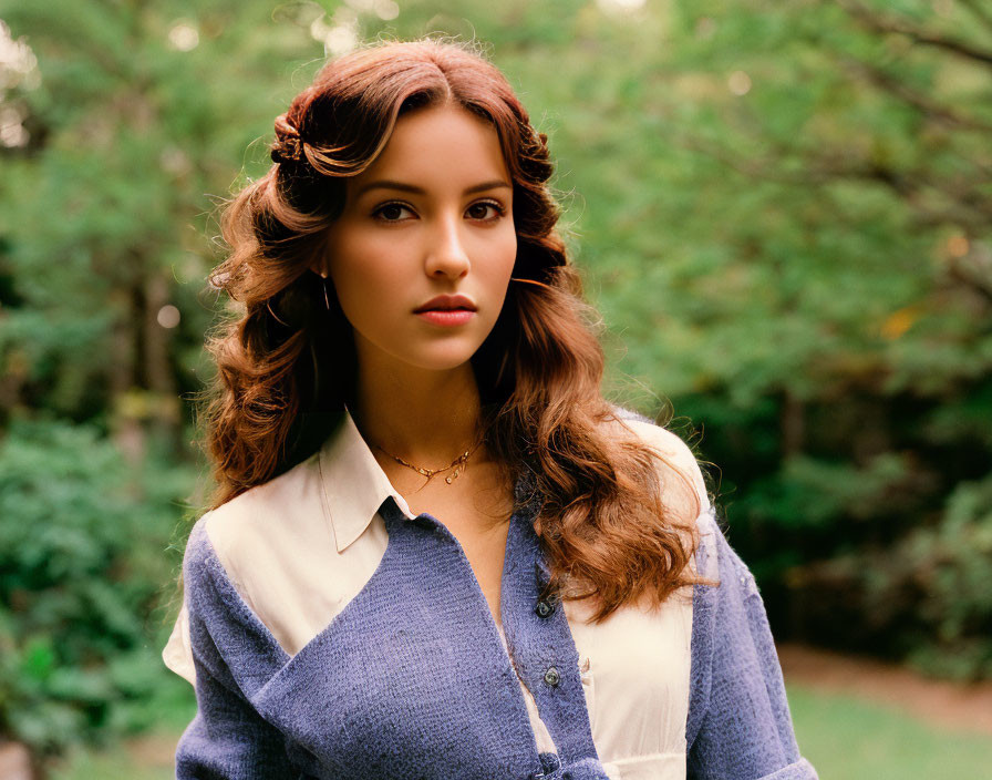 Woman with Brown Wavy Hair in Blue and White Top in Forest Setting