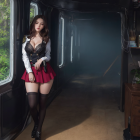 Woman in white blouse and red skirt in foggy train carriage