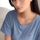 Brown-haired woman in blue shirt with banana pin, subtle gaze