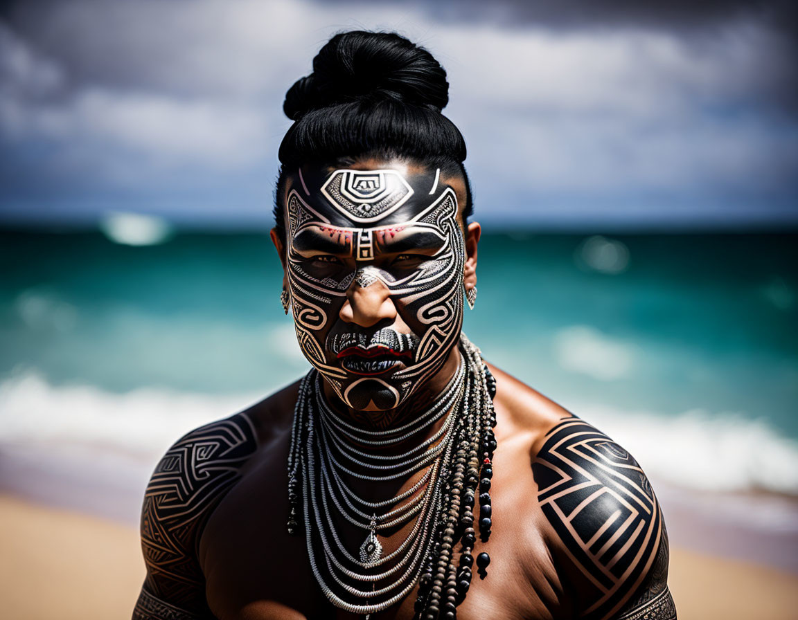 Traditional Maori facial tattoos on person at beach with waves, dark topknot & bone necklace