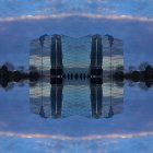 Victorian-style stilted building reflected in twilight alpine landscape