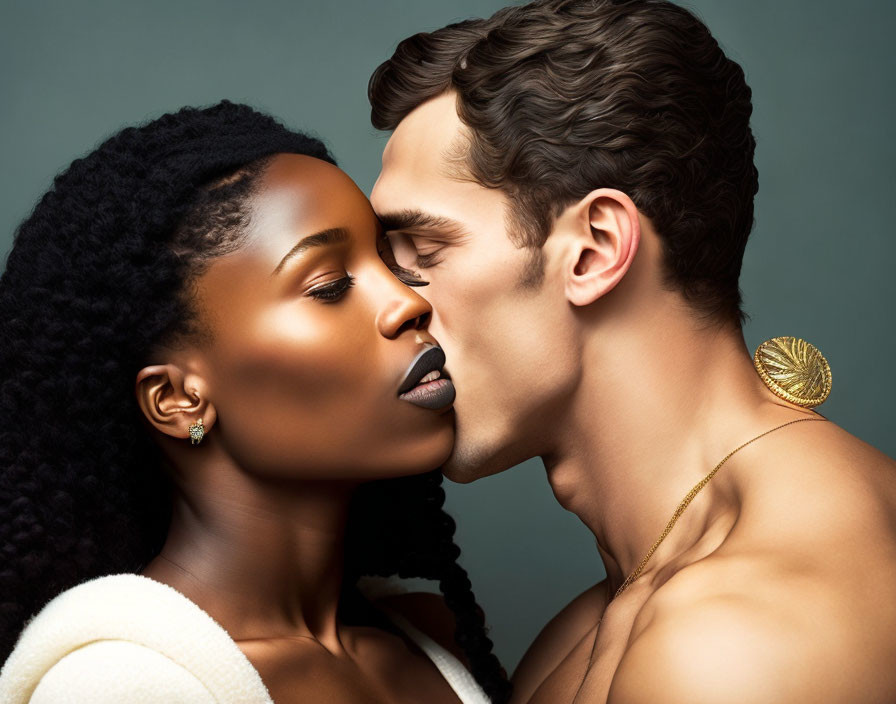 Man and woman in intimate pose with contrasting skin tones and textured hair on muted background