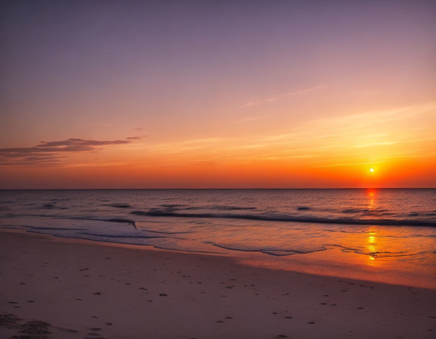 Tranquil Beach Sunset with Orange Sun Setting