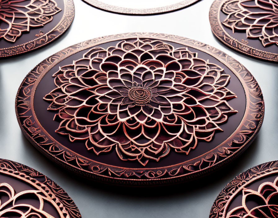 Black and Copper Mandala Decorative Plates on Reflective Surface