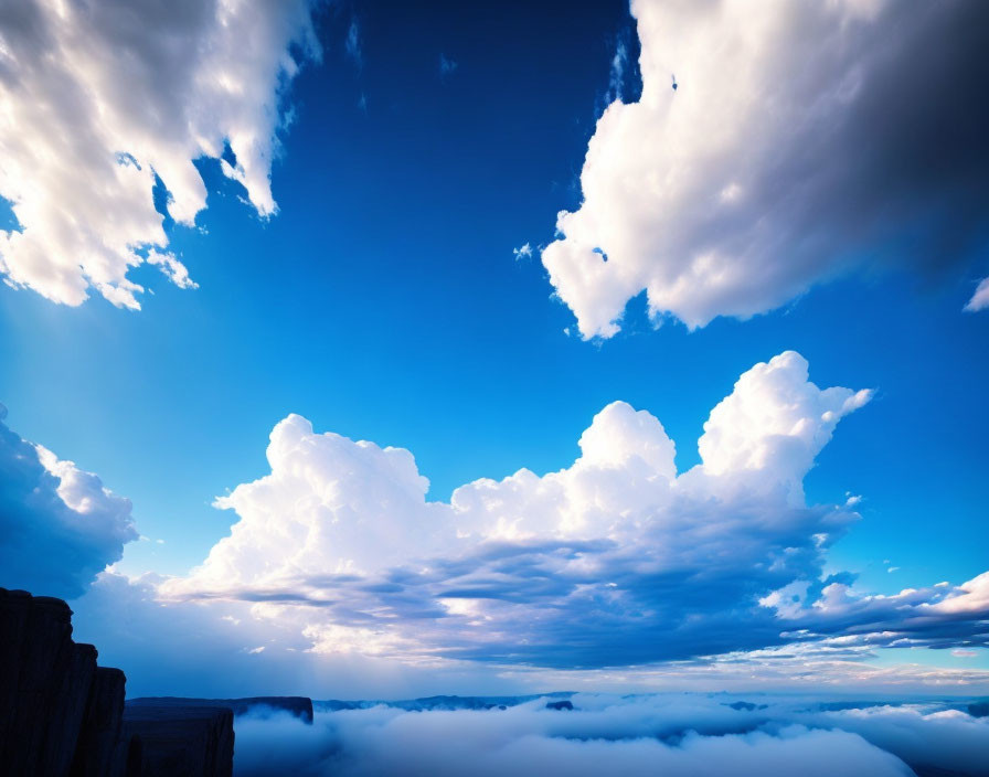 Scenic view of fog-covered cliffs under billowing clouds