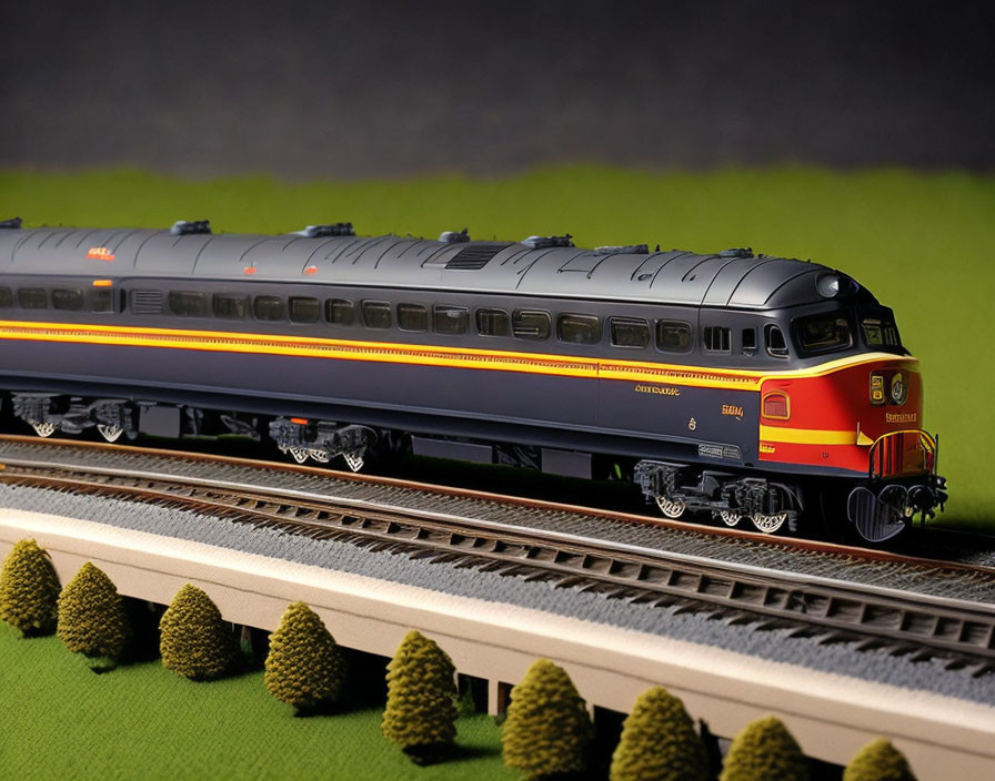 Blue and Yellow Model Train on Track with Miniature Trees