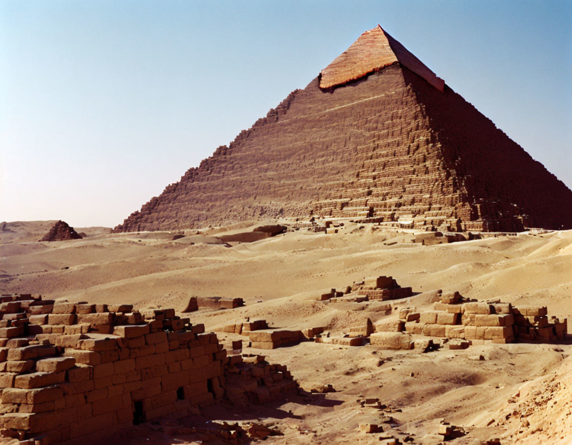 Ancient pyramid with partial capstone in desert ruins