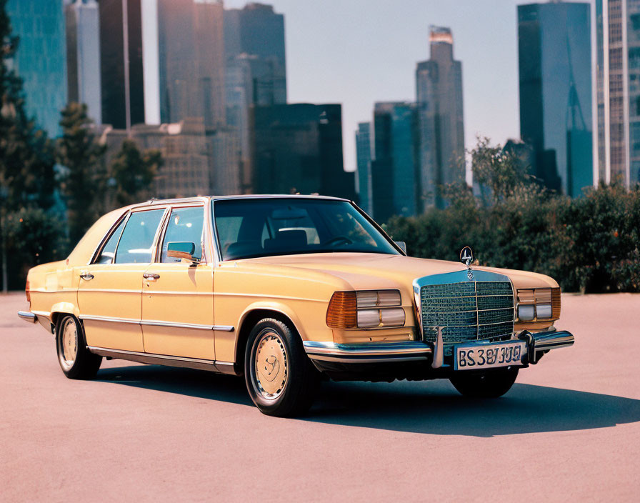 Classic Yellow Sedan Against City Skyline Background