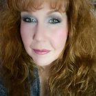 Vibrant portrait of a woman with curly hair and freckles