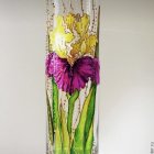 Hand-painted floral design on elegant glass vase - yellow and purple flowers.