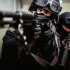 Stylized skull figures with military-style hats on blurred background