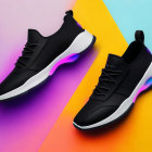 Stylish Black Sneakers with Blue and Purple Accent Lights on Vibrant Geometric Background