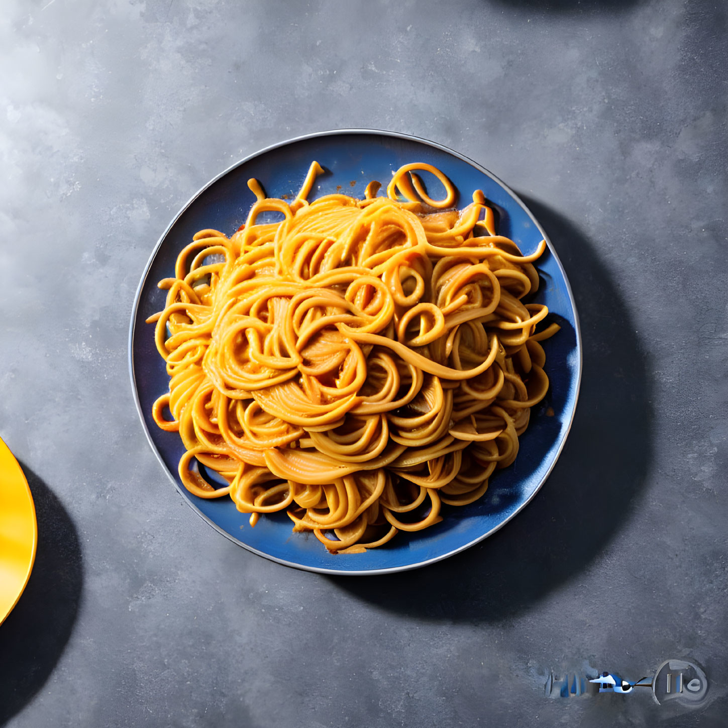 Blue Plate with Spaghetti on Grey Textured Surface