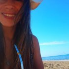 Multicolored hair woman with white hat by sea