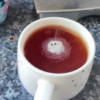 Cosmic coffee cup reflecting swirling galaxy and stars