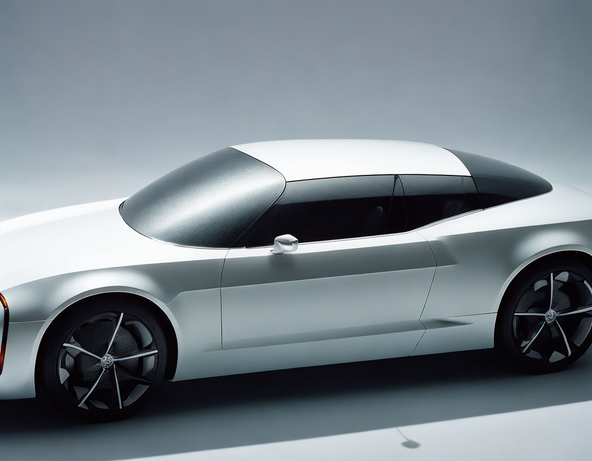 White Coupe with Black Roof and Aerodynamic Rims on Gray Background