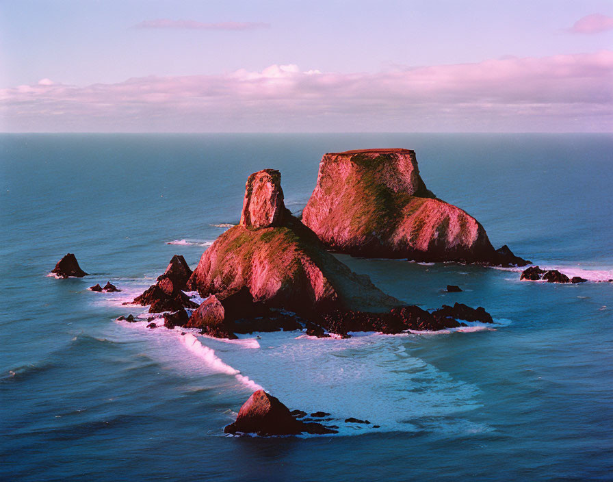 Tranquil seascape with rocky island and dusk sky