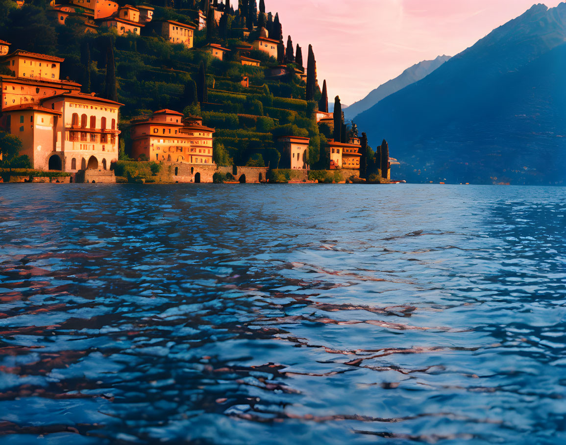 Tranquil lake and hillside village at sunset