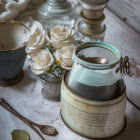 Vintage Still Life: White Roses, Glass Bottles, Feather on Wooden Surface