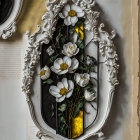 Ornate White Frame with Decorative Floral Relief Encasing White Flowers on Yellow and Black Background