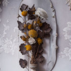 Decorative Oval Mirror with Silver Frame Reflecting Dried Flowers on Gray Wall