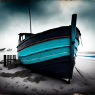 Weathered blue boat on misty beach with wooden fence remnants.