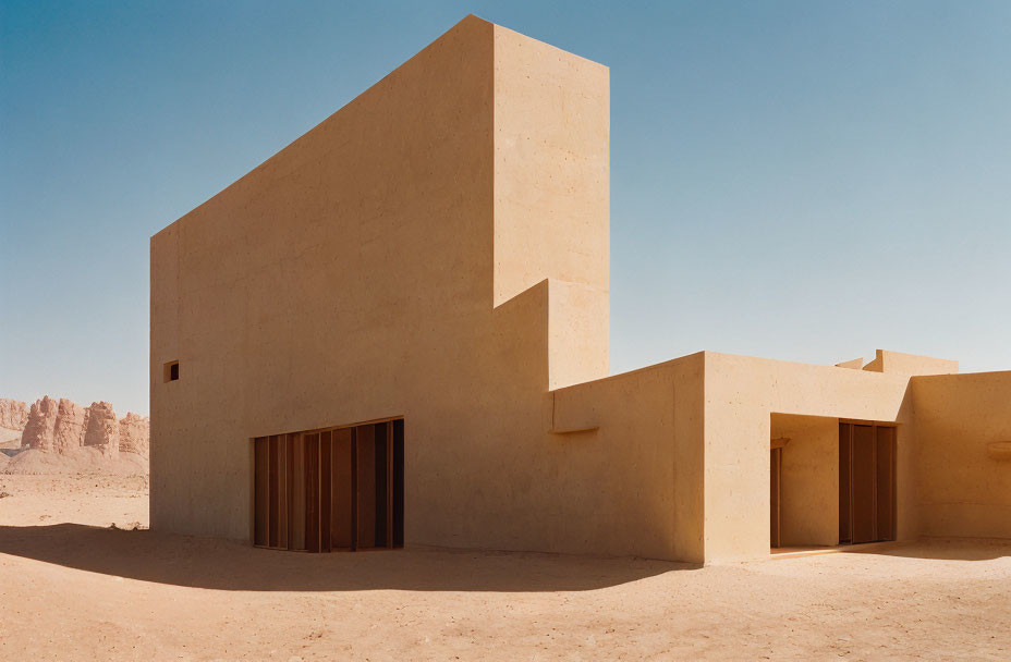 Modern minimalist building with geometric shapes in desert landscape