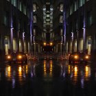 Man in suit plays cello on illuminated city street at night