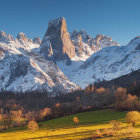 Snow-capped mountain peaks and rocky formations in vast landscape