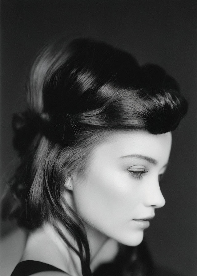 Monochrome portrait of woman with vintage hairstyle and soft lighting