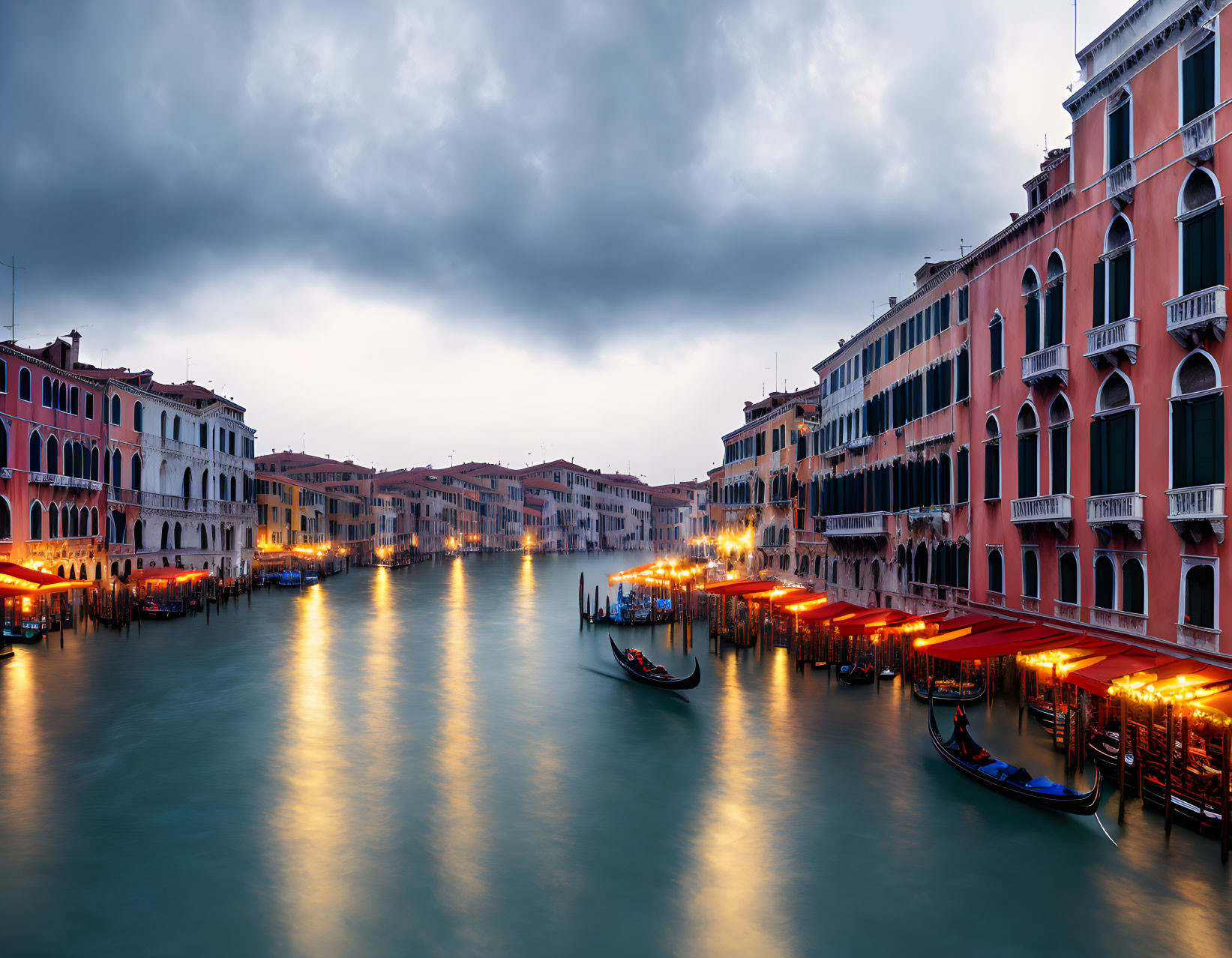 Venice's Grand Canal at Twilight with Illuminated Storefronts