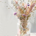 Delicate wildflowers in purple and white in clear glass vase