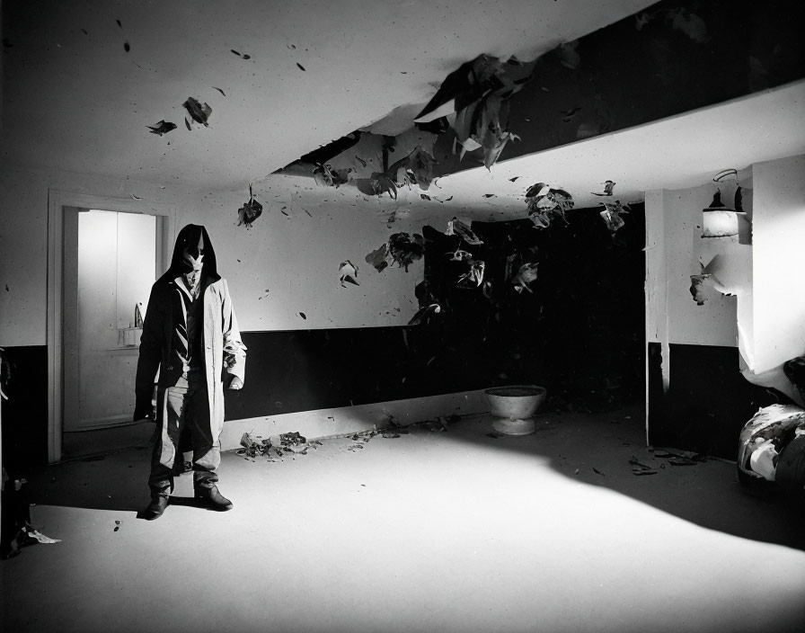 Person in Hooded Jacket in Dilapidated Room with Stark Lighting