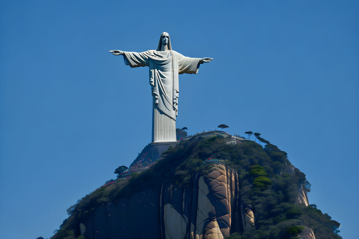 Giant Jesus Christ statue on mountain under clear sky