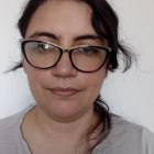 Woman with Blue Eyes, Dark Hair, Glasses, and White Top