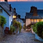 Tranquil coastal dusk with thatched cottages, wooden boat, flowers, and sailboats near