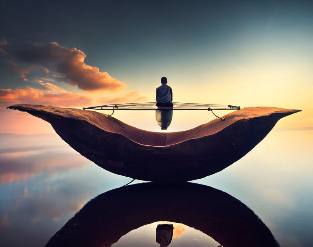 Person in boat on calm water at sunrise/sunset