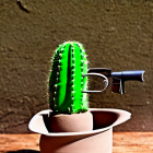 Surreal cowboy with cactus body and futuristic gun in desert setting