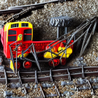 Two orange and black trains on railway junction under clear daylight