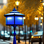 Vibrant blue street lamp in warm twilight cityscape