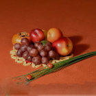 Ornate green and red patterned plates with decorative beetle on red surface