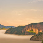 Misty mountains and serene lake with autumn trees