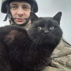 Soldier with Beret and Black Cats in Soft Background