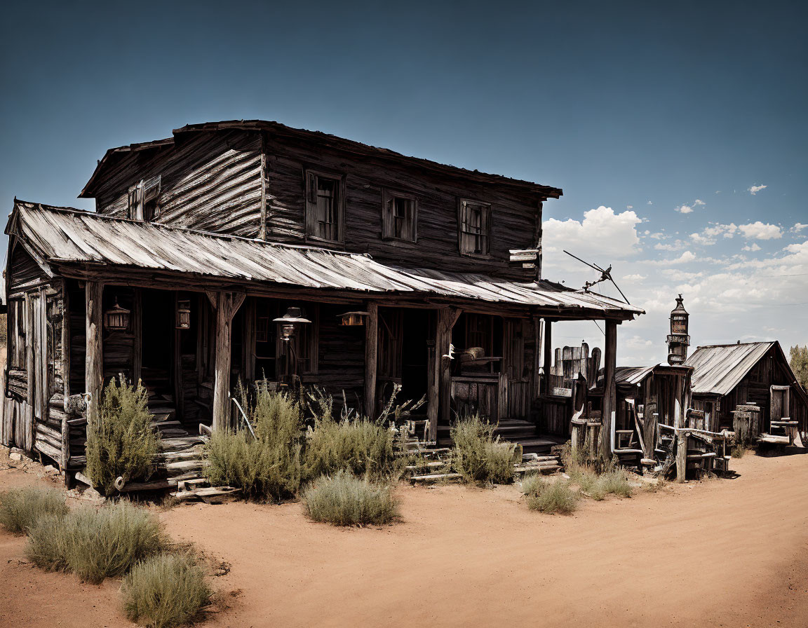 Two-story wooden building with porch in desert landscape