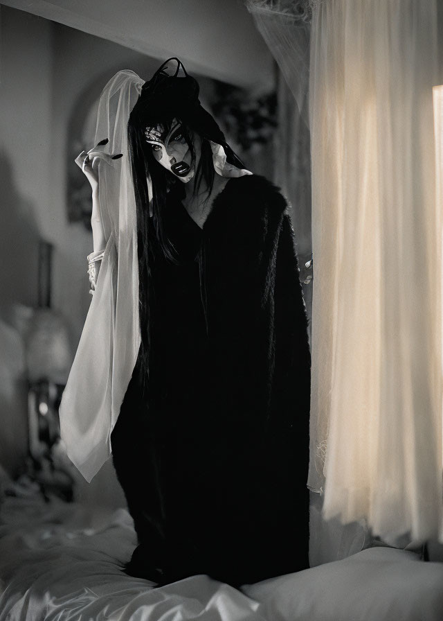 Gothic costume with horned headpiece and dramatic makeup in dimly lit room