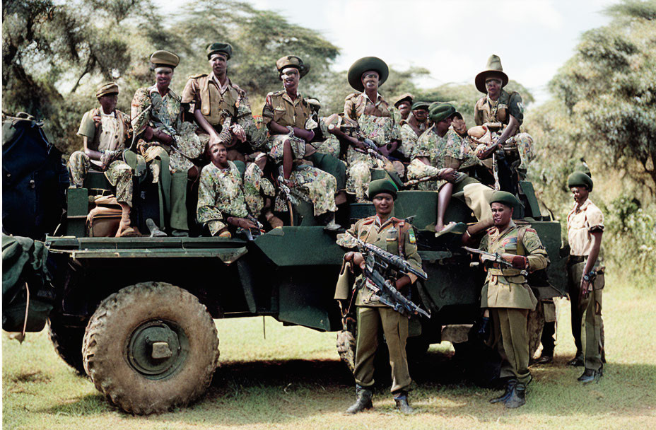 Soldiers in Different Uniforms with Weapons by Military Vehicle in Grassy Area